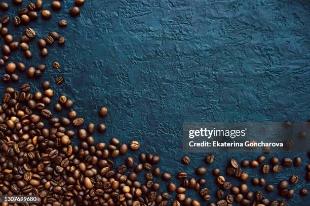 coffee beans on a beautiful dark blue-green concrete background. - coffee bean bildbanksfoton och bilder