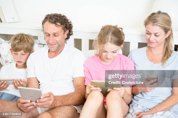 Someone Using Multiple Devices Family Using Multiple Devices Photos and Premium High Res Pictures ...