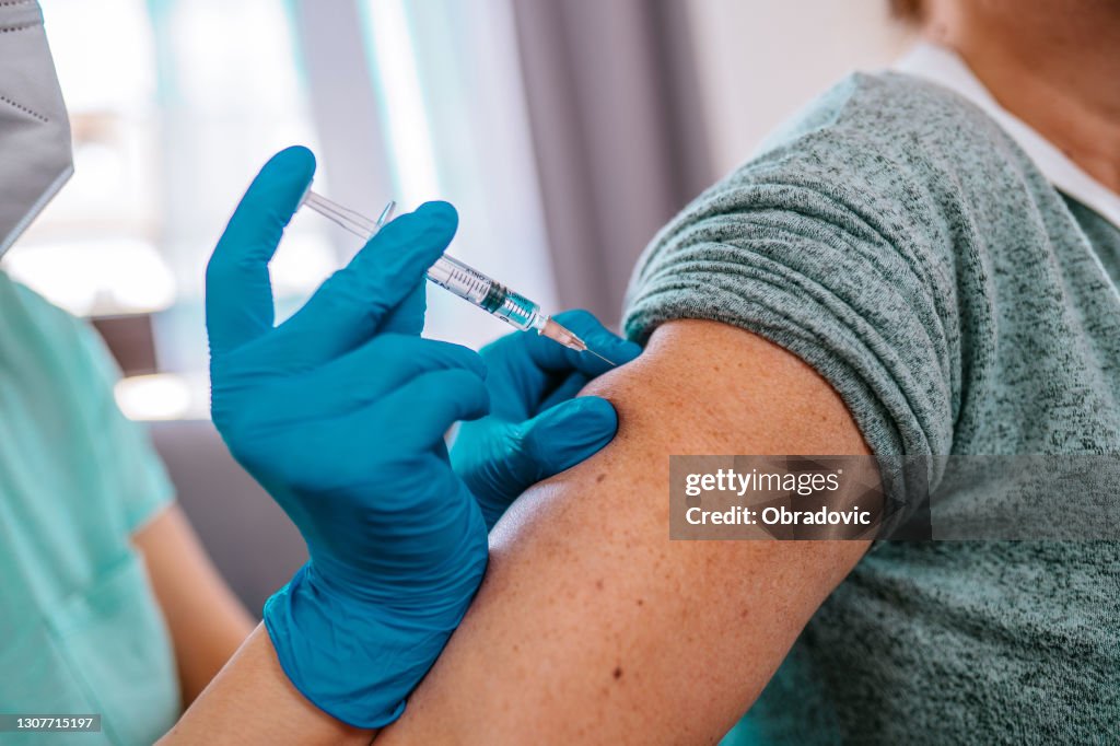 Patient getting vaccination at home