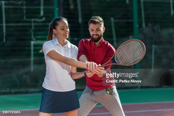 two young people training on the tennis court - mission court grip stock pictures, royalty-free photos & images