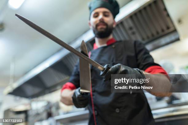 male chef sharpening his knives - apron gloves stock pictures, royalty-free photos & images