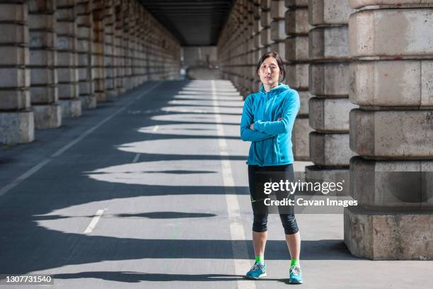 woman at a metro viaduct in paris - center athlete stock pictures, royalty-free photos & images