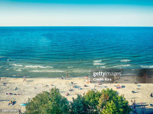 aerial view of people on beach along the baltic coast, poland - baltic sea poland stock pictures, royalty-free photos & images