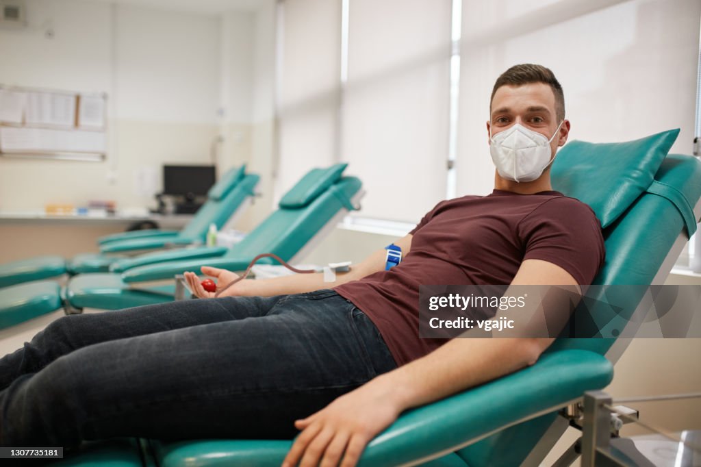 Young Male Donor Donating Blood During Coronavirus Pandemic