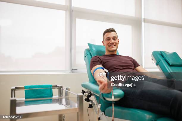 young male donor donating blood - blood stock pictures, royalty-free photos & images