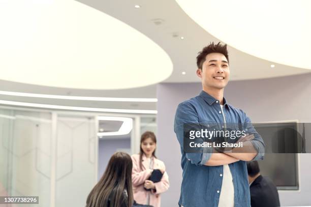 portrait of confident asian business man in the office - chinese male confident stock pictures, royalty-free photos & images