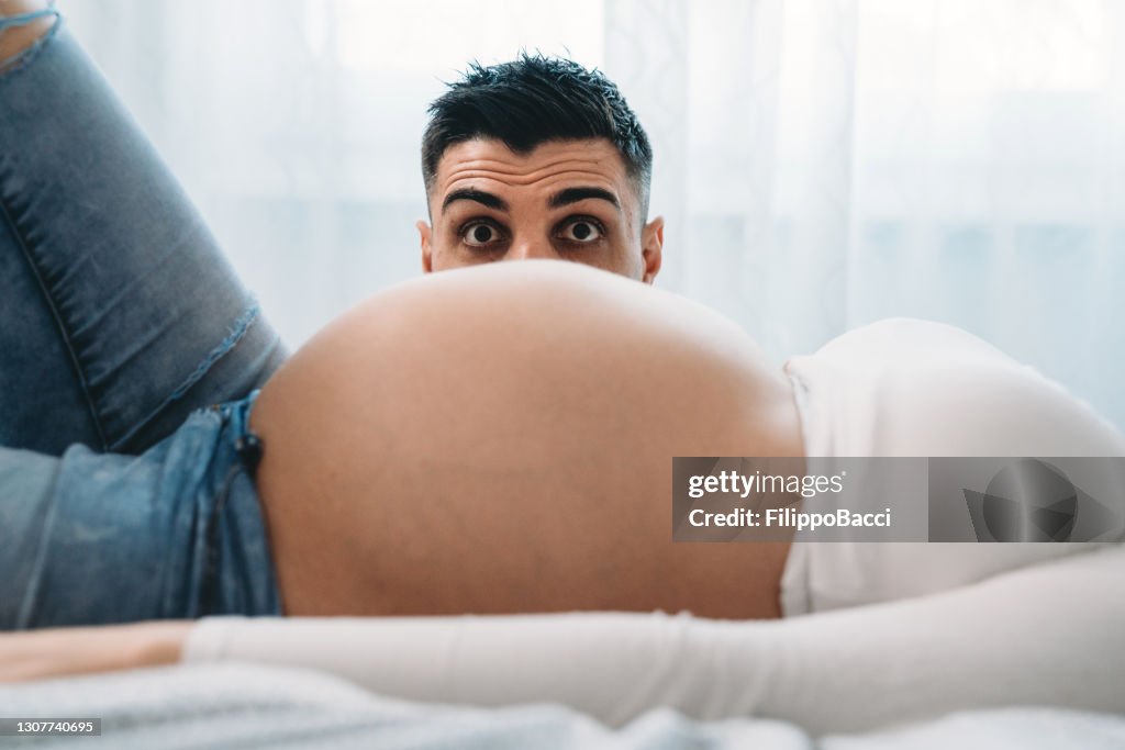 Funny Shot Of A Man Popping Up Behind Her Wifes Pregnant Belly High-Res Stock Photo - Getty Images Funny Shot Of A Man Popping Up Behind Her Wifes Pregnant Belly High-Res Stock Photo - Getty Images