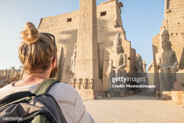 man explores ancient temples in egypt - temple of luxor stock pictures, royalty-free photos & images