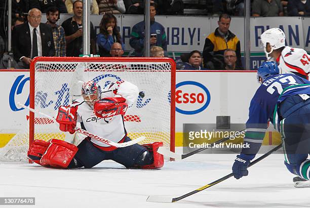 Alexander Edler of the Vancouver Canucks scores his second goal against Michal Neuvirth of the Washington Capitals while Joel Ward of the Capitals...