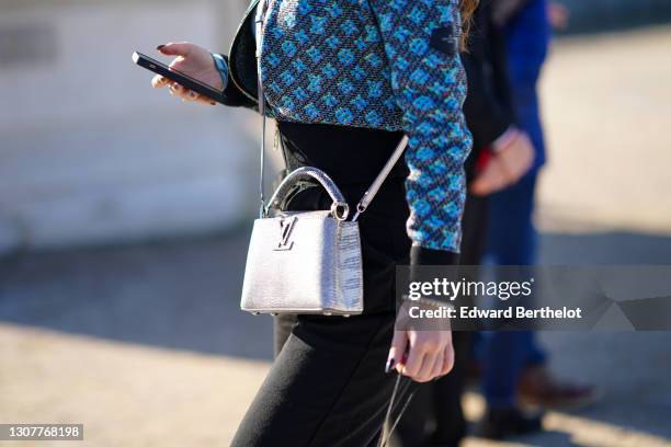 A guest wears a pearl bracelet, a Louis Vuitton Monogram Turquoise News  Photo - Getty Images