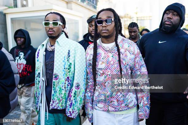 Quavo wears pale green Louis Vuitton sunglasses, diamond earrings and ring, silver chain necklace, black Louis Vuitton sweatshirt with embroidery LV,...