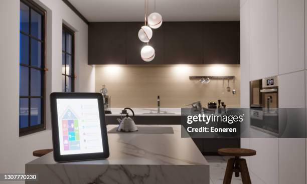 smart home control in kitchen - smart homes stock pictures, royalty-free photos & images