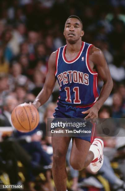 Isiah Thomas, Point Guard for the Detroit Pistons dribbles the basketball down court during the NBA Midwest Division basketball game against the...