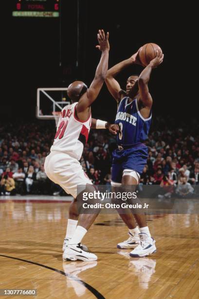 Terry Porter, Point Guard for the Portland Trail Blazers attempts to block the pass from Hersey Hawkins of the Charlotte Hornets for the basketball...