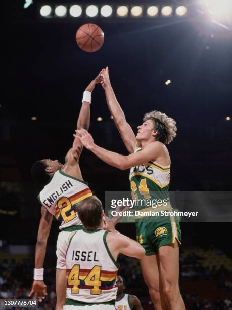 Tom Chambers, Power Forward for the Seattle SuperSonics challenges for the basketball at the tip off with Alex English of the Denver Nuggets during...
