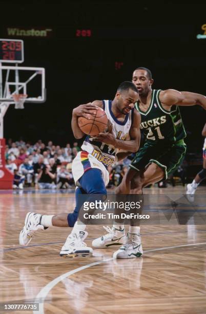 Michael Adams, Point Guard for the Denver Nuggets drives to the basket around Alvin Robertson of the Milwaukee Bucks during their NBA Midwest...