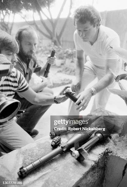 Embassy Public Affairs Officer Don Hamilton shows journalist Mike O'Connor rocket propelled grenades captured from the Frente Farabundo Marti para la...