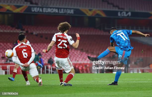 Youssef El Arabi of Olympiakos scores their side's first goal during the UEFA Europa League Round of 16 Second Leg match between Arsenal and...