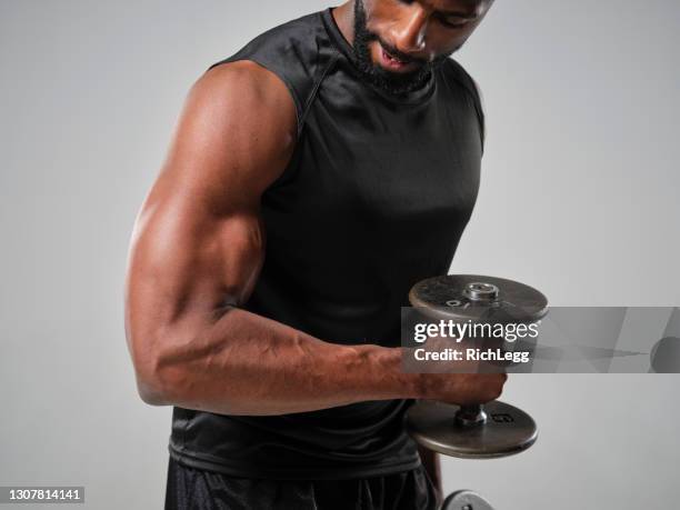 physically fit man in a studio - physically active stock pictures, royalty-free photos & images