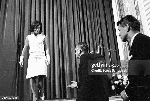 As US Attorney General Robert Kennedy watches, his sister-in-law and former US First Lady Jacqueline Kennedy leaves the stage during the Democratic...