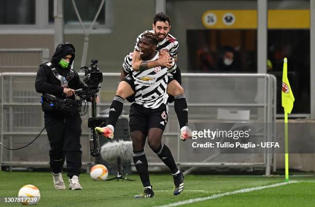 Paul Pogba of Manchester United celebrates with Bruno Fernandes after scoring their side's first goal during the UEFA Europa League Round of 16...