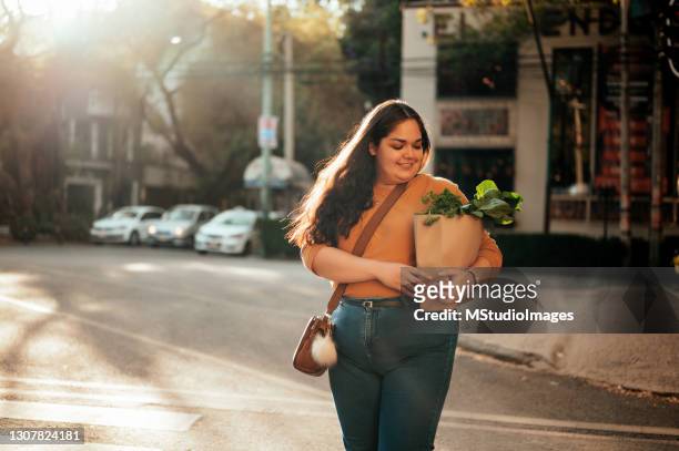 woman crossing street - three quarter length stock pictures, royalty-free photos & images