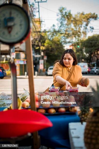 woman buying fruit - mexican street market stock pictures, royalty-free photos & images