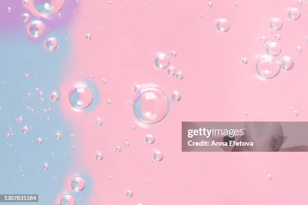 texture of organic transparent gel with many air bubbles smudged on pastel blue, pink and purple background. concept of skin moisturizing or prevention covid-19 during pandemic. close-up and flat lay style - make up background stock pictures, royalty-free photos & images