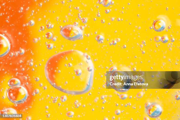 texture of organic transparent aloe vera gel or moisturizing lotion with many air bubbles on orange illuminating yellow blue background. concept of skin care procedures with healthy cosmetic products. close-up and flat lay style with copy space - vitamine c stockfoto's en -beelden