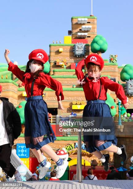 Visitors wearing Mario costumes enjoy the 'Super Nintendo World' new attraction area at the Universal Studio Japan on March 18, 2021 in Osaka, Japan.