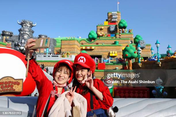 Visitors wearing Mario costumes enjoy the 'Super Nintendo World' new attraction area at the Universal Studio Japan on March 18, 2021 in Osaka, Japan.