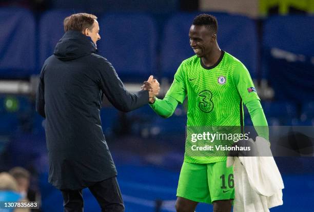 Chelsea Coach Thomas Tuchel and goalkeeper Edouard Mendy celebrate after winning the UEFA Champions League Round of 16 match between Chelsea FC and...