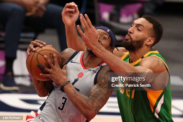 Bradley Beal of the Washington Wizards drives in the lane past Rudy Gobert of the Utah Jazz during the second half at Capital One Arena on March 18,...
