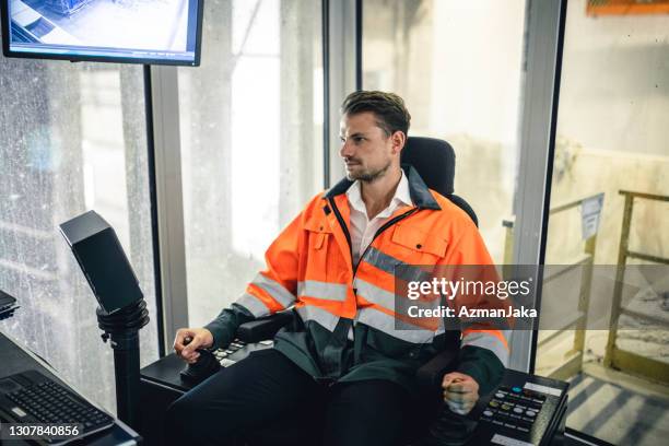 serious young male recycling expert in control room - joy stick stock pictures, royalty-free photos & images