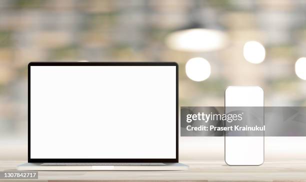 laptop with blank screen and smartphone on table. mockup - laptop on desk no people stock pictures, royalty-free photos & images