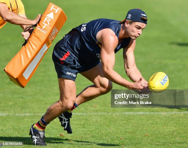 Ben Keays of the Crows handballs during the Adelaide Crows AFL training session at West Lakes on March 19, 2021 in Adelaide, Australia.