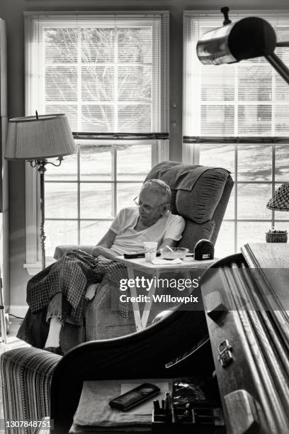 elderly senior man great grandpa sleeping in living room - widower stock pictures, royalty-free photos & images