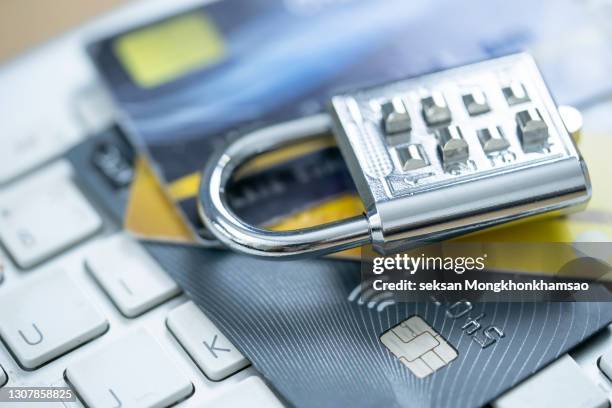 security lock on credit cards with computer keyboard - credit card data security - fraud protection stock pictures, royalty-free photos & images