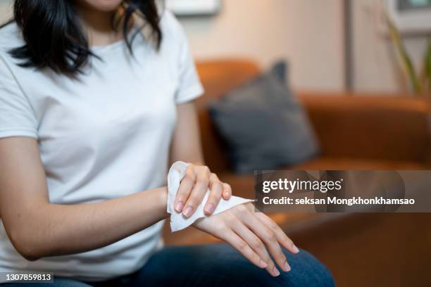 woman cleaning her hands with a tissue. healthcare and medical concept. - papiertaschentuch stock-fotos und bilder