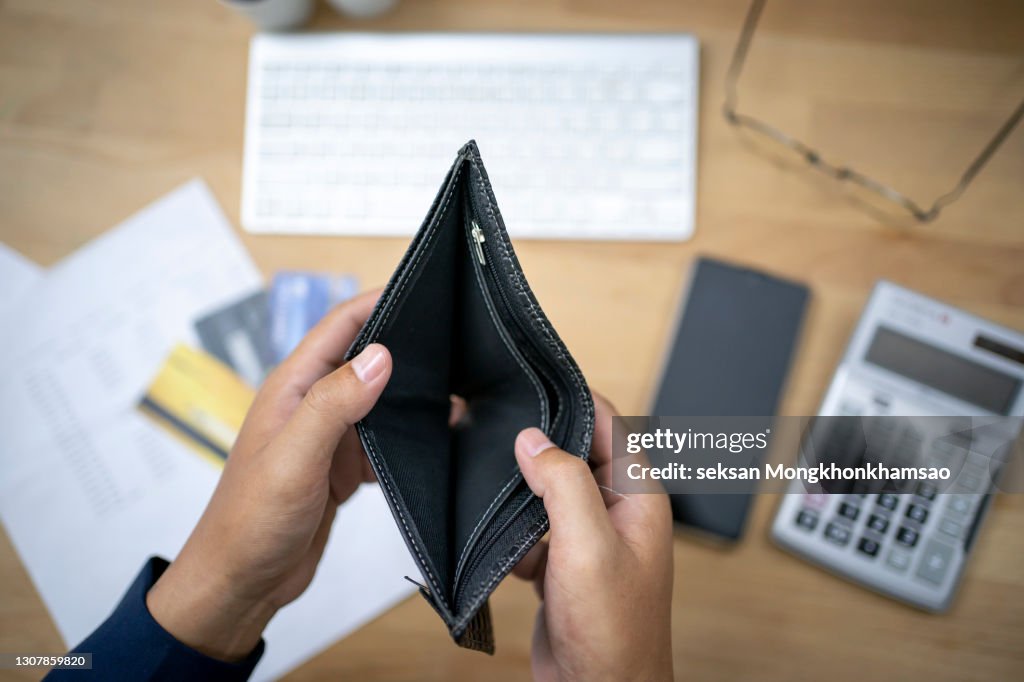 Hand open empty purse looking for money having problem bankrupt broke