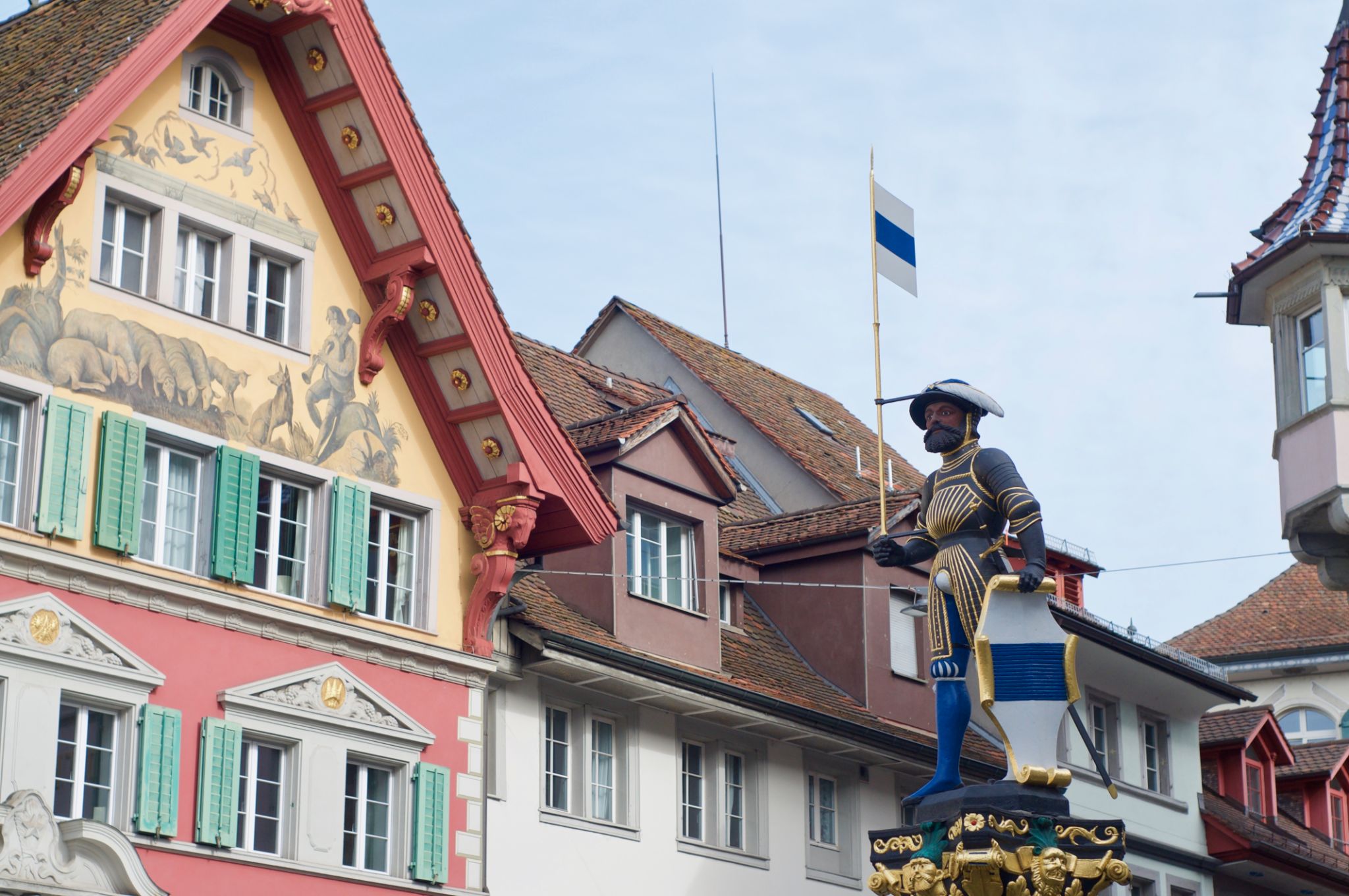 Kolinbrunnen fountain statue with traditional buildings in Zug Kolinbrunnen fountain statue with traditional buildings in Zug