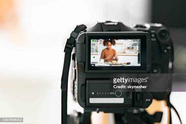 close up of making a video of black girl eating in dining room. - digital single lens reflex camera stock pictures, royalty-free photos & images