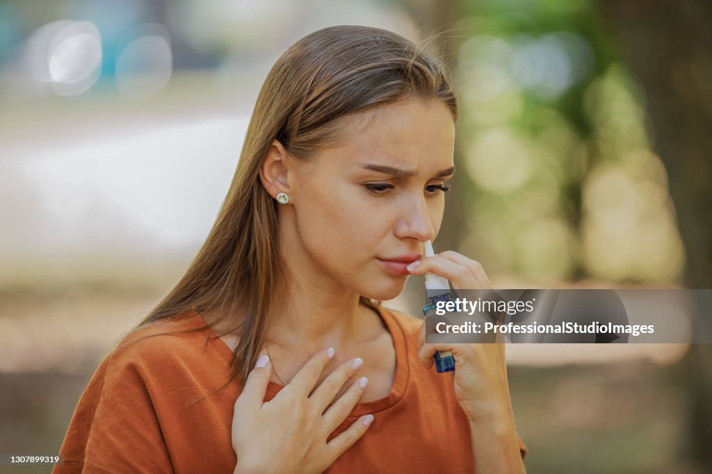 Young Woman is Having Sinusitis Problems Outside in Nature.