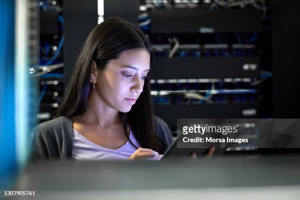female engineer working in server room - data centre stock pictures, royalty-free photos & images