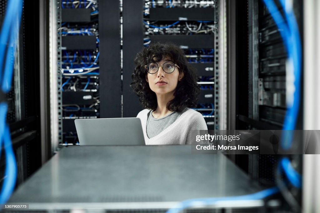 Female technician standing in server room