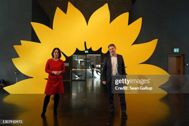 Robert Habeck and Annalene Baerbock, co-leaders of the German Greens Party, pose for photos after a livestreamed, digital press conference to...