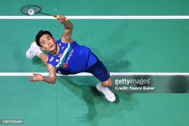 Kento Momota of Japan returns a shot during his Quarter Final match against Lee Zii Jia of Malasyia during day three of YONEX All England Open...