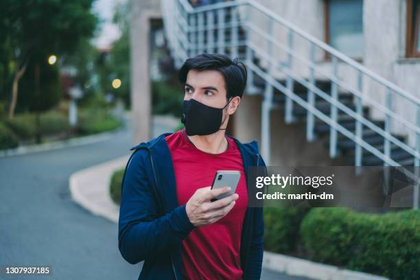 man wearing protective face mask, covid-19 pandemic - dialling stock pictures, royalty-free photos & images