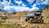4x4 Side-by-Side off-road vehicle, UTV ATV with a beautiful mountain range in the background near Ouray, Colorado. Yankee Boy Basin. Rocky Mountains.