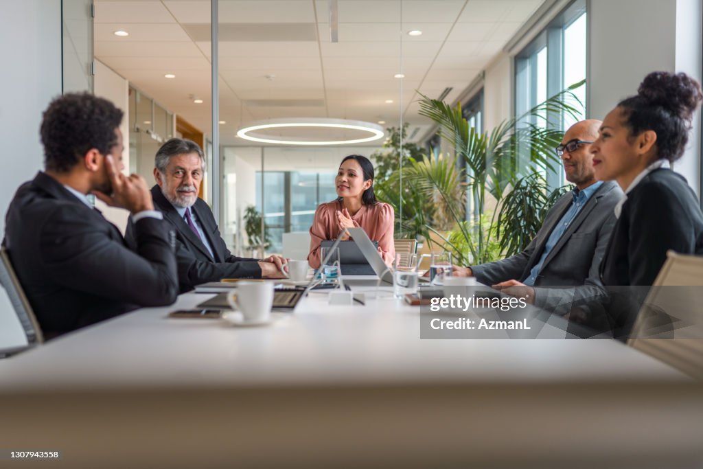 Asian Businesswoman Conducting Business Meeting in Boardroom